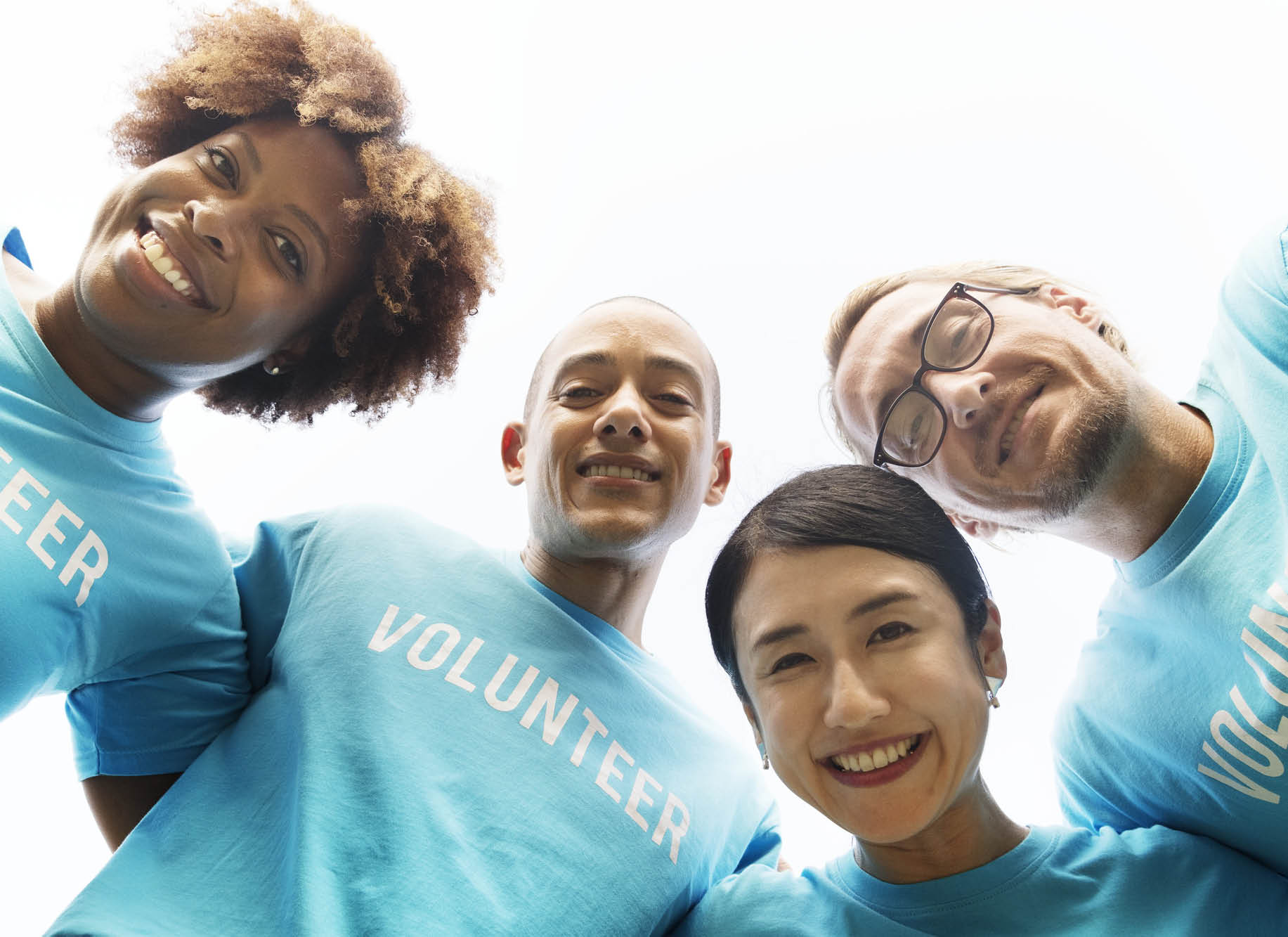 Volunteers looking down at camera.