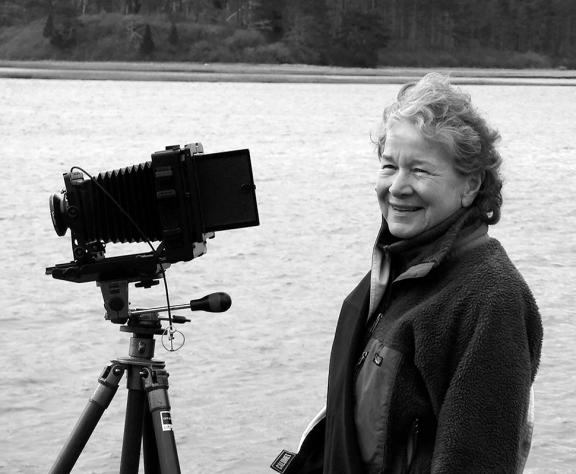 Dorothy Kerper Monnelly with her camera by a lake.