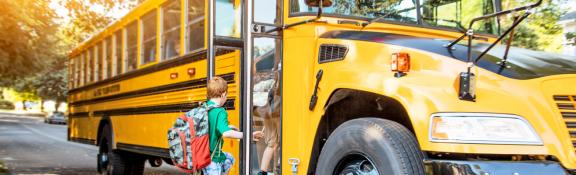 Kids getting on school bus.