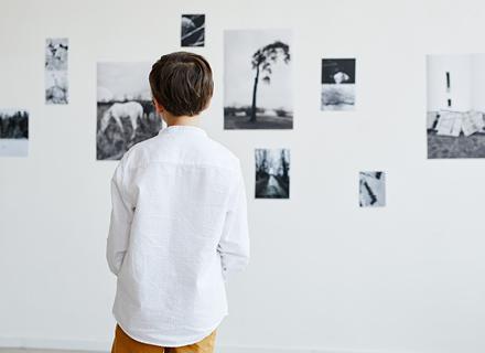 Male student looking at art.