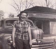 Barbara "JoAnn" Johnson in classic photo in front of a car.
